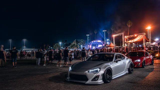 A nighttime automotive event with a lit stage